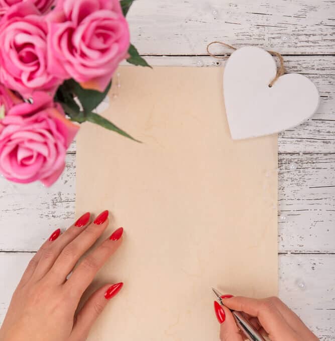 woman writing love letter for husband