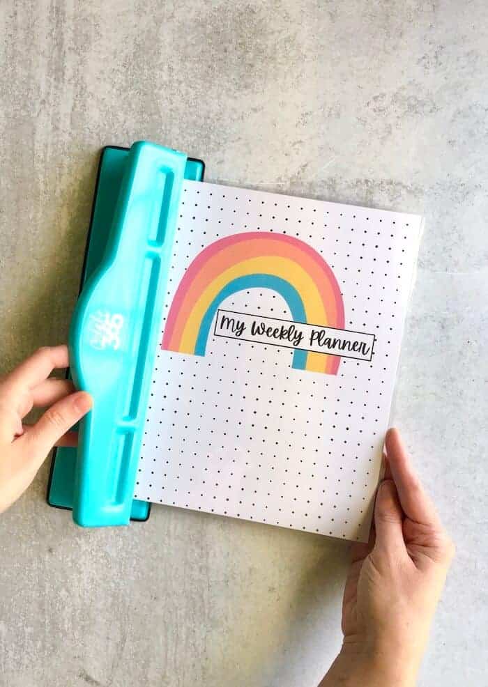 hole punching a DIY Happy Planner cover using the Happy Planner punch
