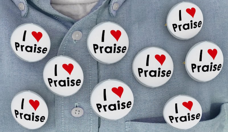 buttons that say I love praise on a man's shirt