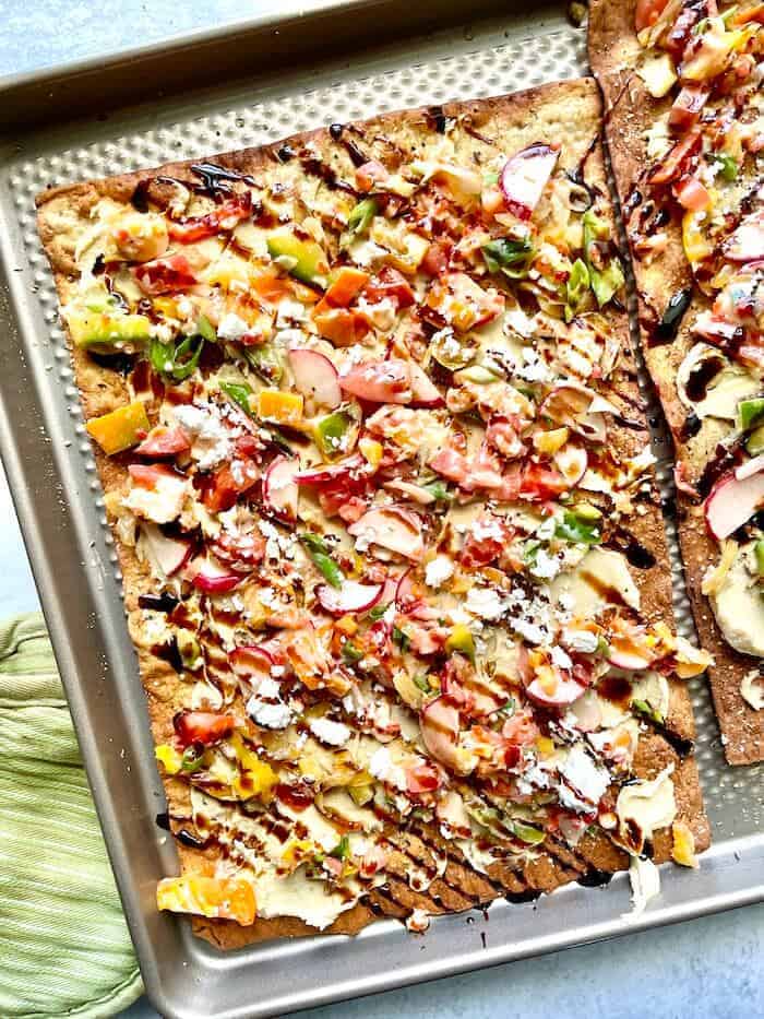 vegetarian flatbread with hummus and chopped vegetables