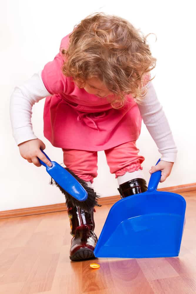 little girl doing chores