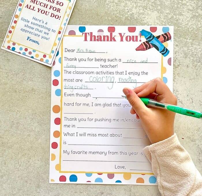 child writing a thank you letter for teacher