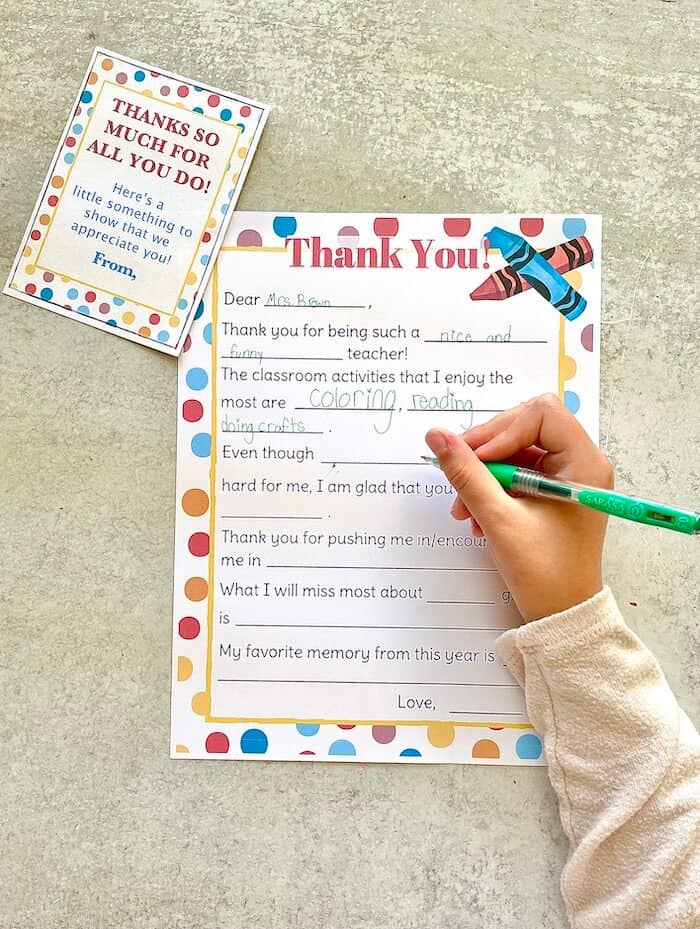 child writing a thank you letter for teacher