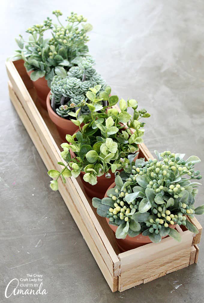 DIY wood planter box with potted plants inside