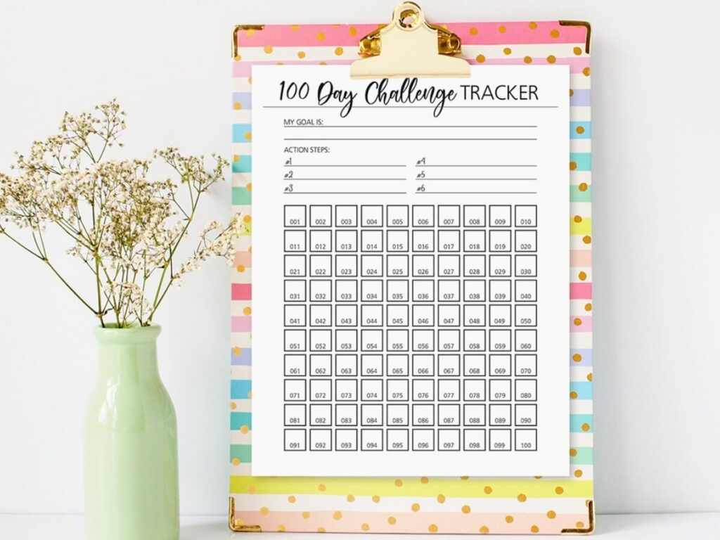 printable 100 day challenge tracker on a clipboard