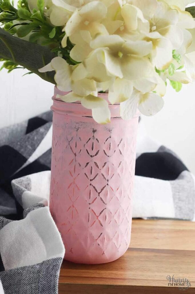 mason jar painted pink used as a vase