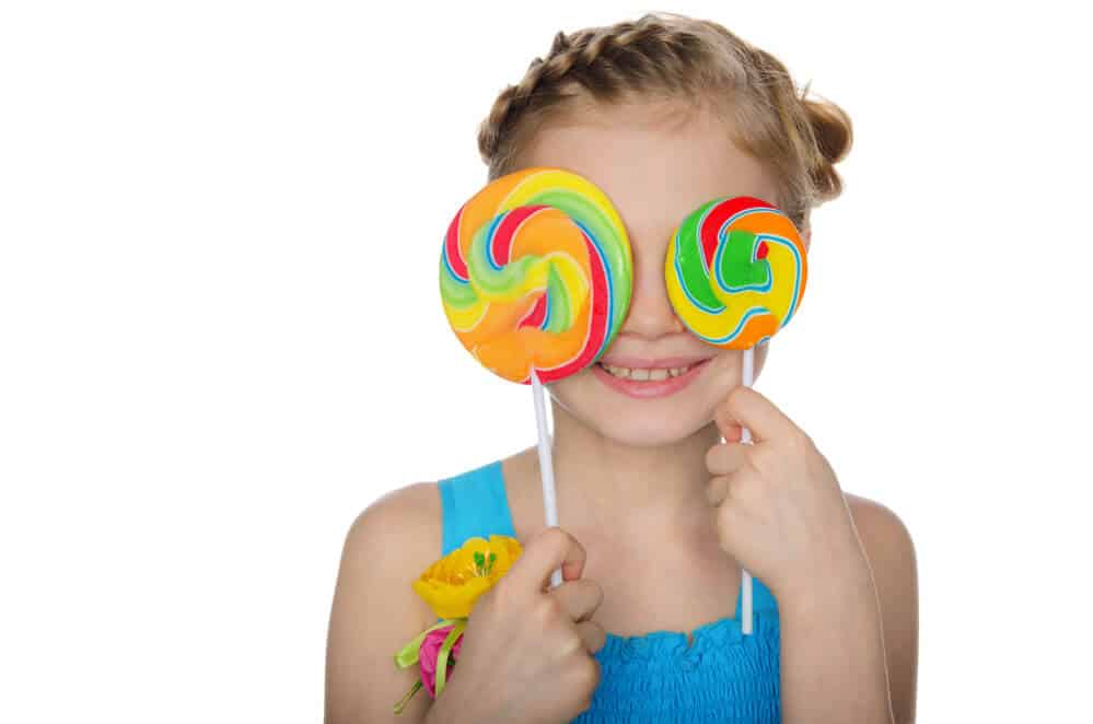 little girl with 2 lollipops