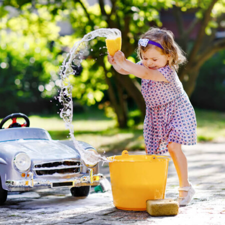 little girl washing her toy car