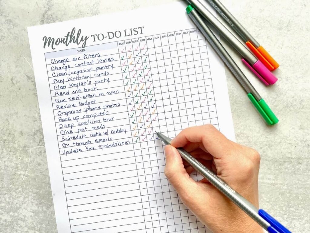 woman writing a monthly to do list