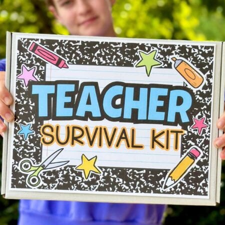 girl holding a teacher survival kit gift box
