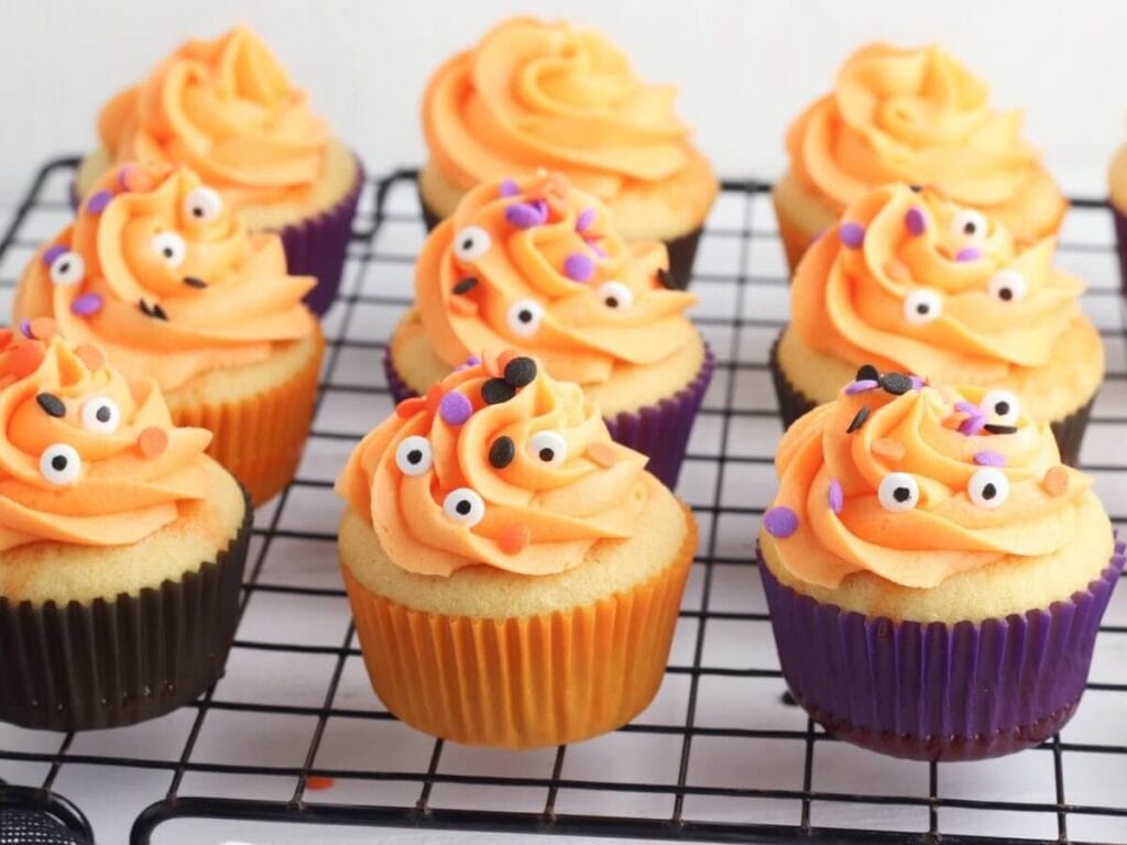 orange poke cake Halloween cupcakes on a cooling rack