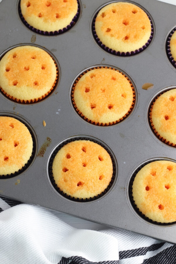 Halloween poke cake cupcakes with jello mix poured into the holes