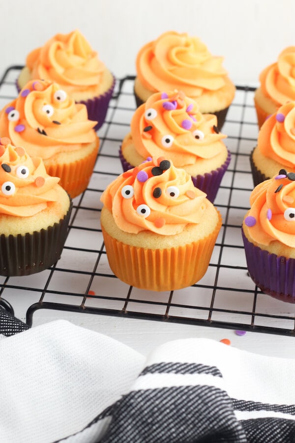 Halloween cupcakes decorated with orange icing and sprinkles