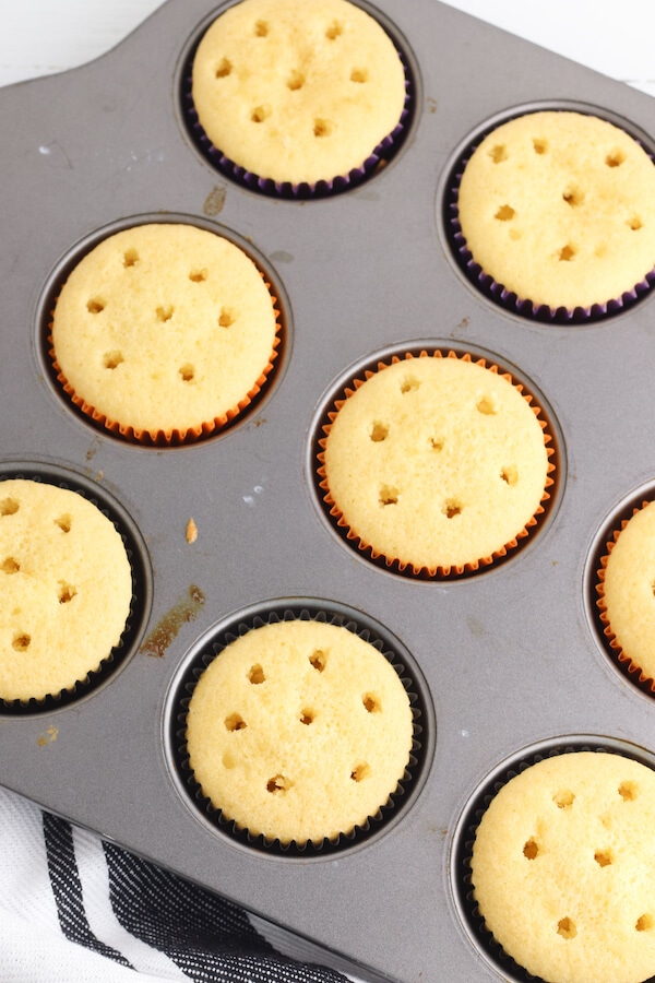 yellow cake cupcakes with holes poked in them