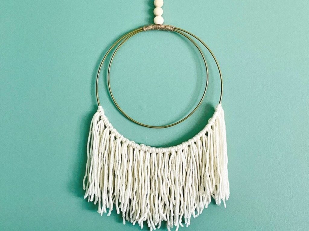 DIY boho wall hanging made with yarn and gold hoops