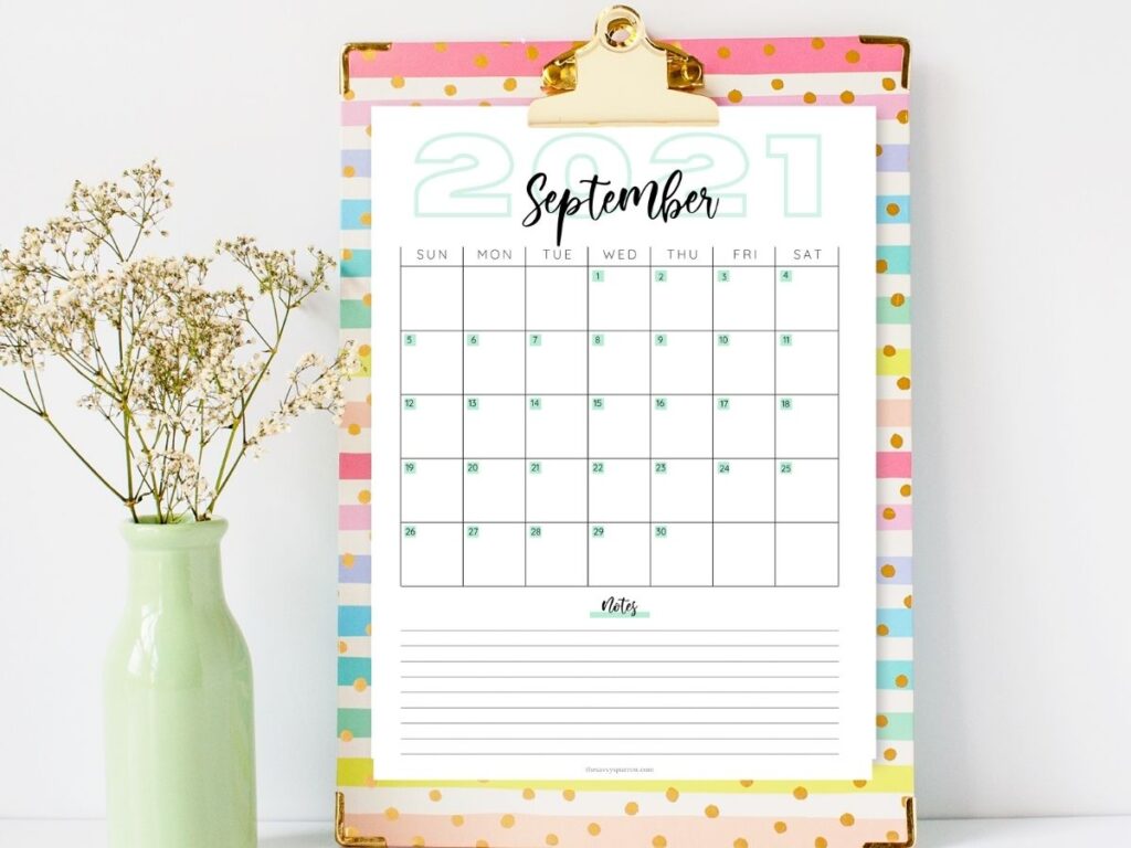 printable September calendar PDF on a colorful clipboard