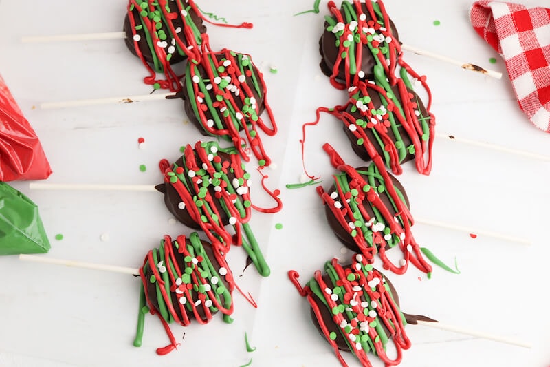 chocolate covered ritz cracker cookie pops decorated with red and green chocolate