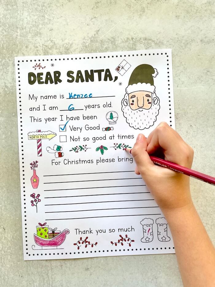 child coloring a Dear Santa letter