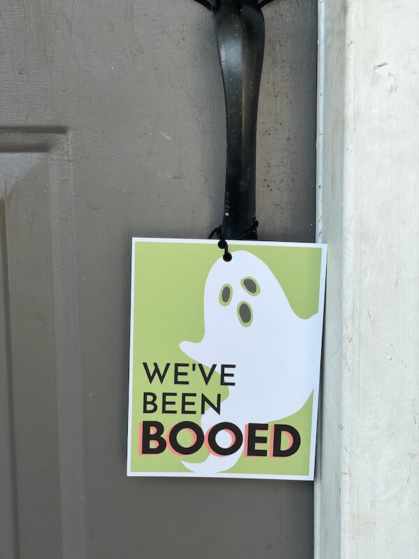 We've been booed printable sign hanging on a front door