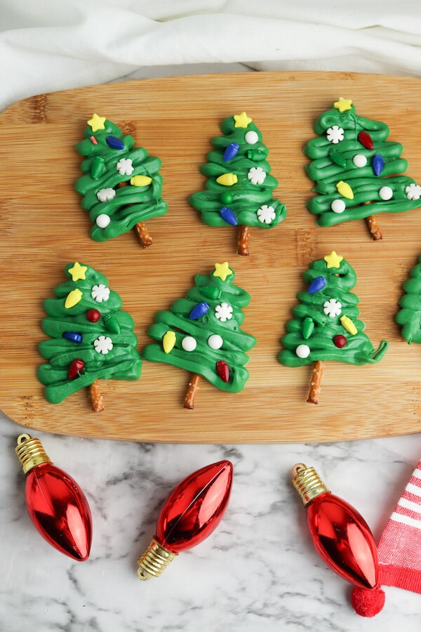 chocolate Christmas tree pretzel treats on a cutting board