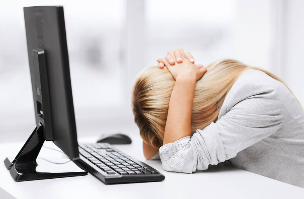 stressed out woman sitting at a computer