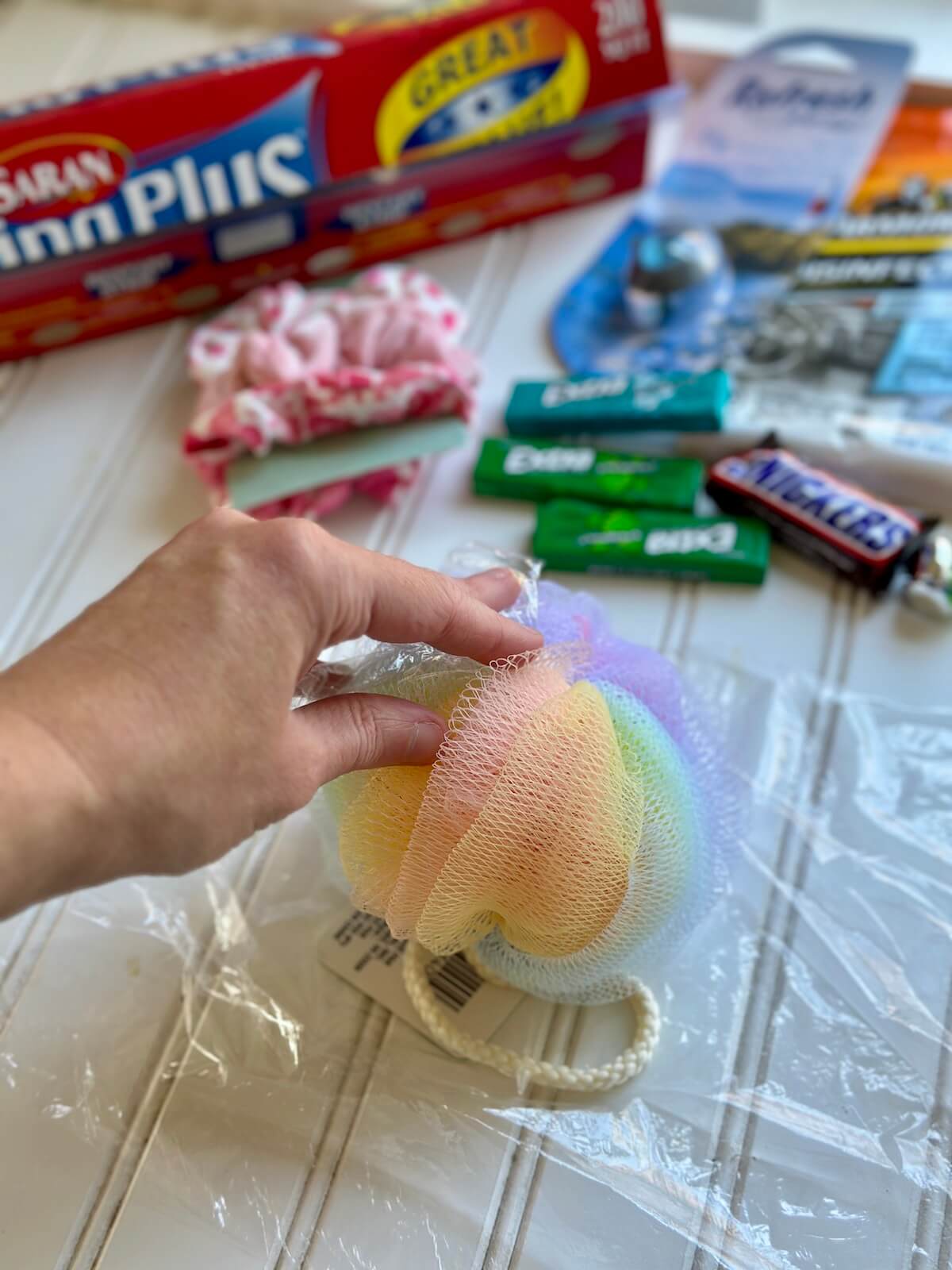 starting to make a Saran wrap ball game with a loofah in the middle