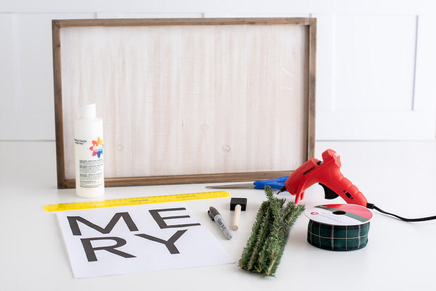 unfinished wood sign, paint, ruler, hot glue gun, and Merry sign template