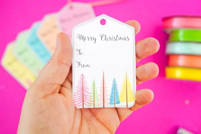 gift tag that says Merry Christmas with colorful trees