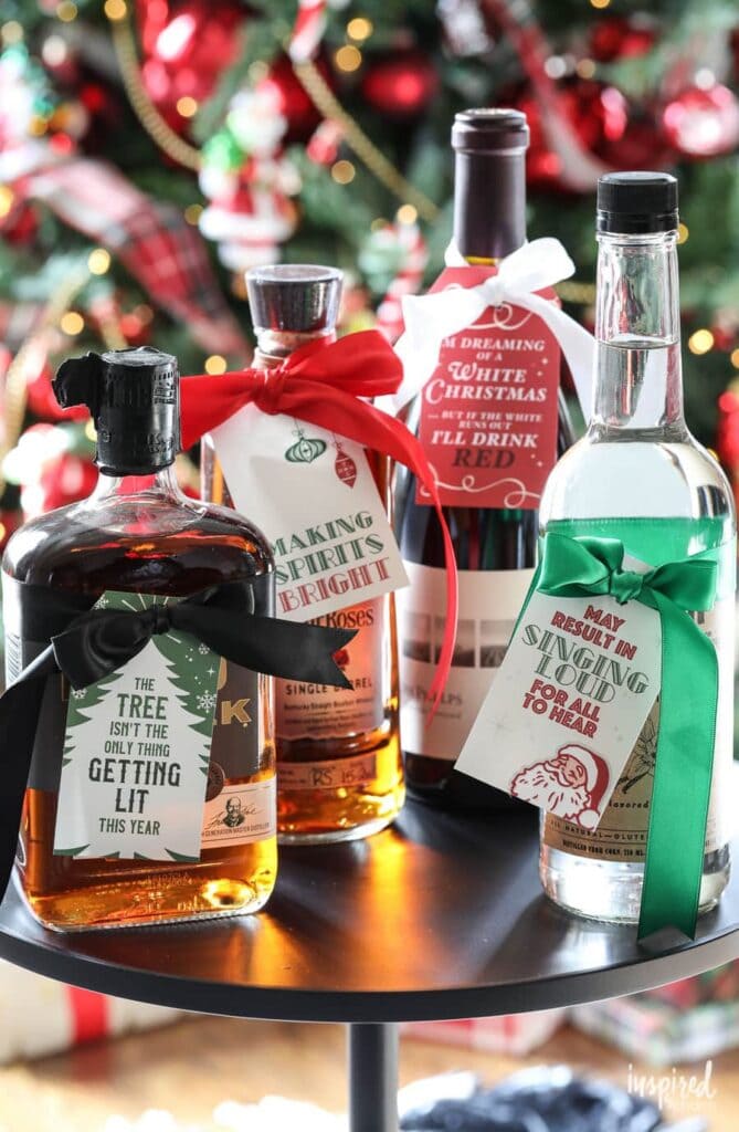 printable Christmas gift tags hanging on liquor bottles