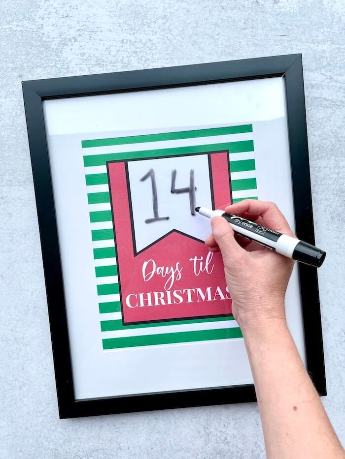 using a dry erase marker on a glass frame to change days til christmas