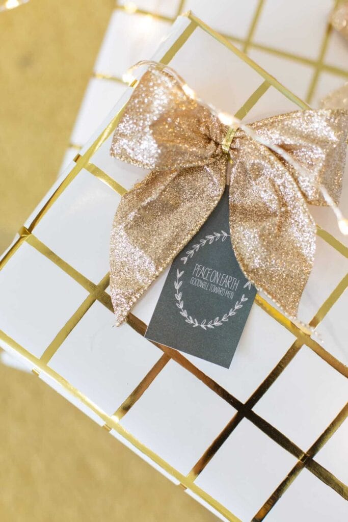 Christmas gift tag that says "Peace on Earth" on a gold wrapped gift