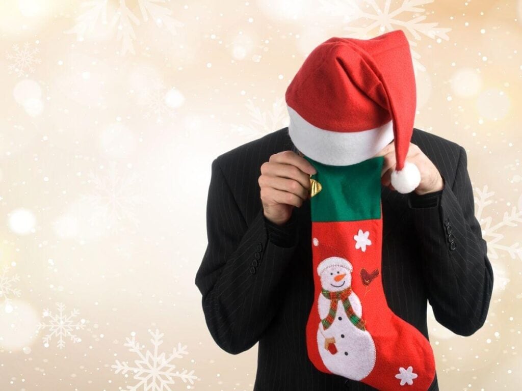 man looking into a Christmas stocking
