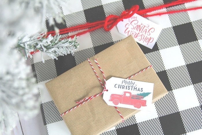 black and white check wrapped present with a vintage red truck gift tag