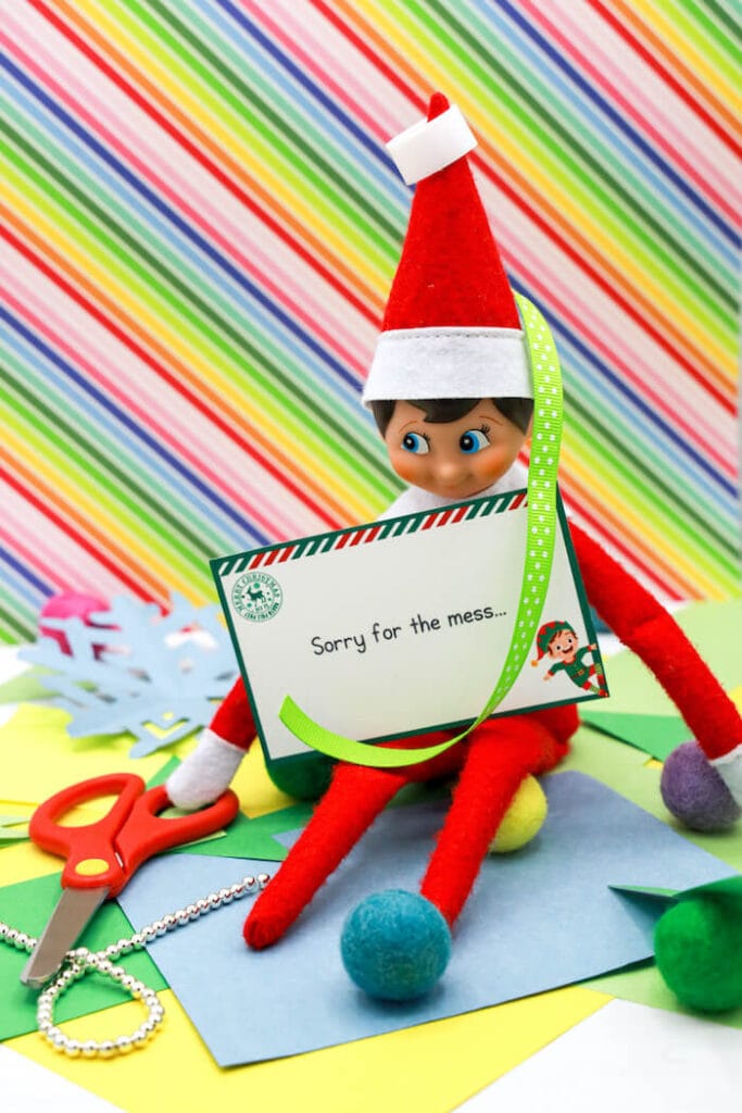 elf on the shelf holding a note that says sorry for the mess