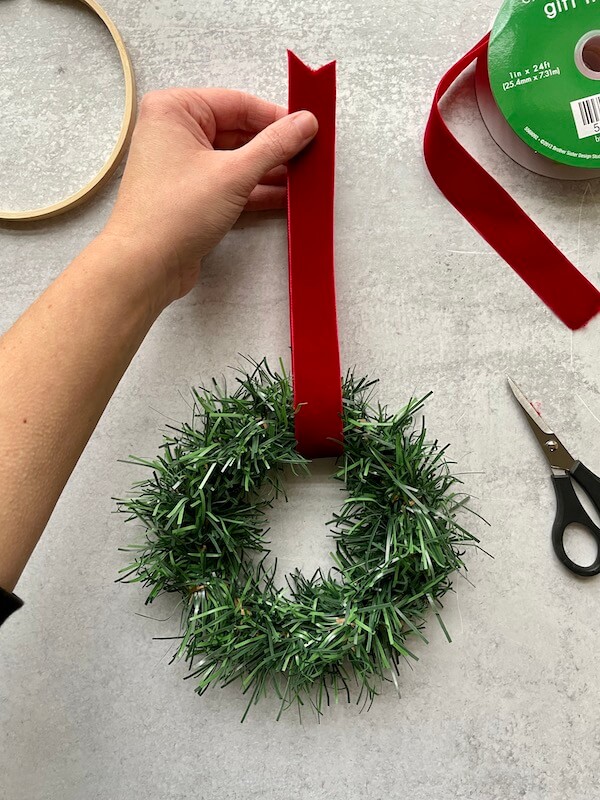 attaching velvet ribbon to a DIY mini Christmas wreath