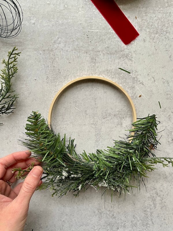 embroidery hoop with evergreen stems wired on to it