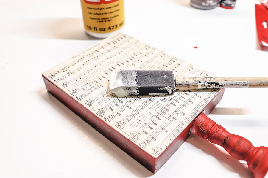 gluing an old song sheet to a Valentines sign