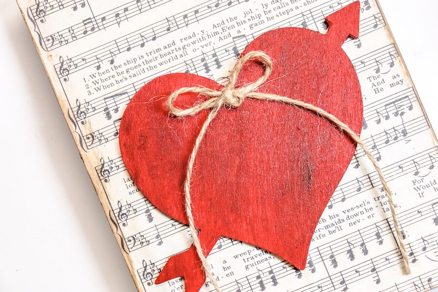 DIY Valentines sign craft with a wood heart and song sheet