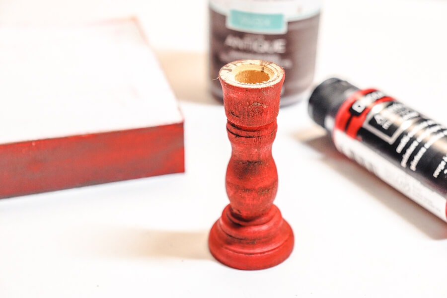 wood candlestick painted red
