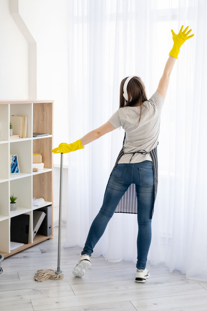 woman listening to music while cleaning
