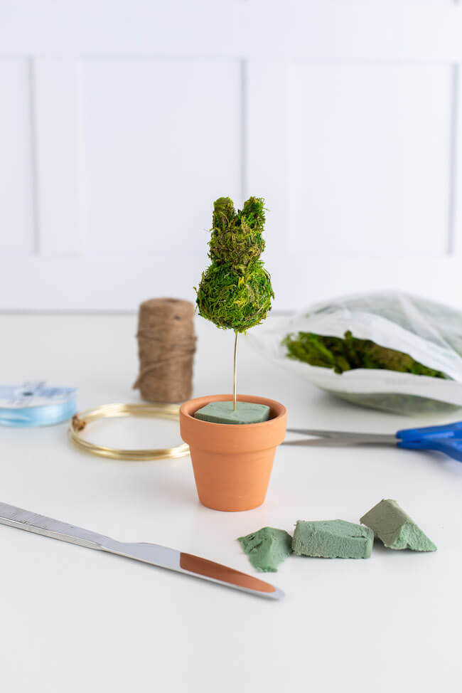 moss bunny in a terra cotta pot with floral foam