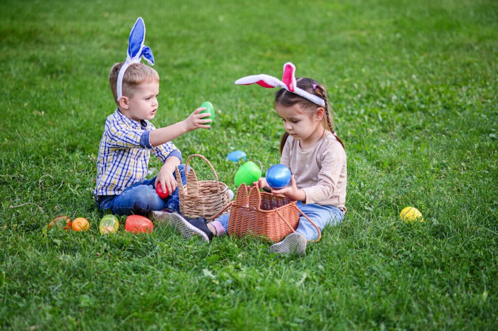 kids opening plastic Easter eggs during an egg hunt