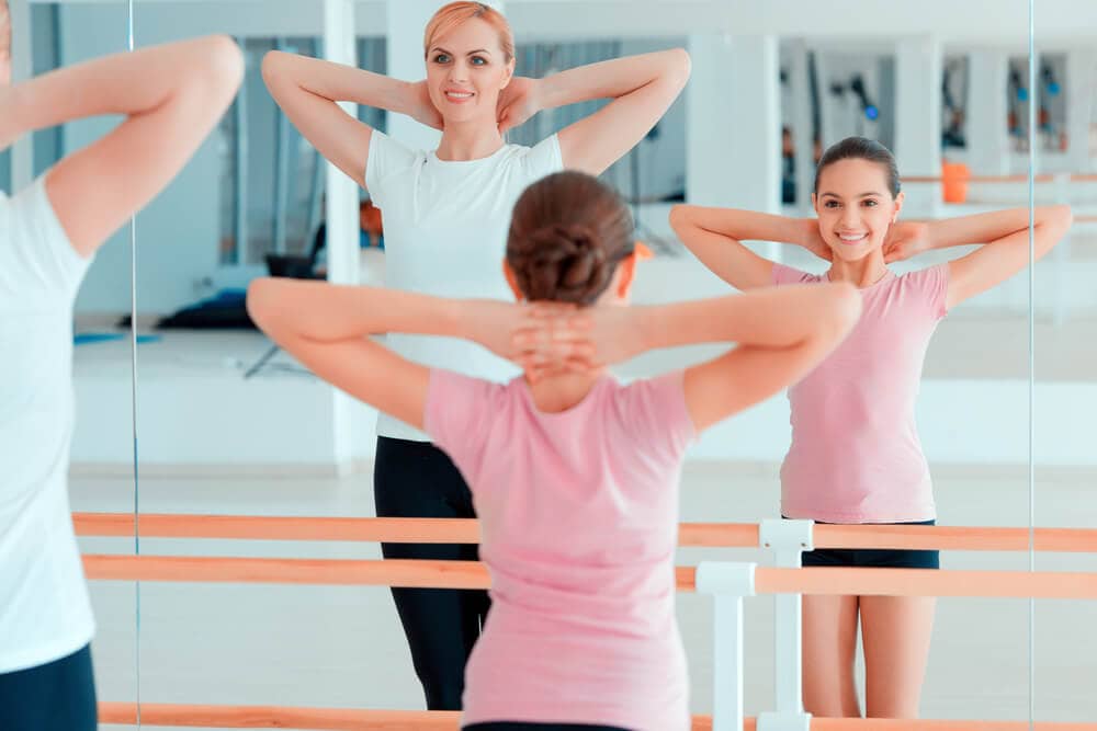 mother and daughter taking a yoga class together