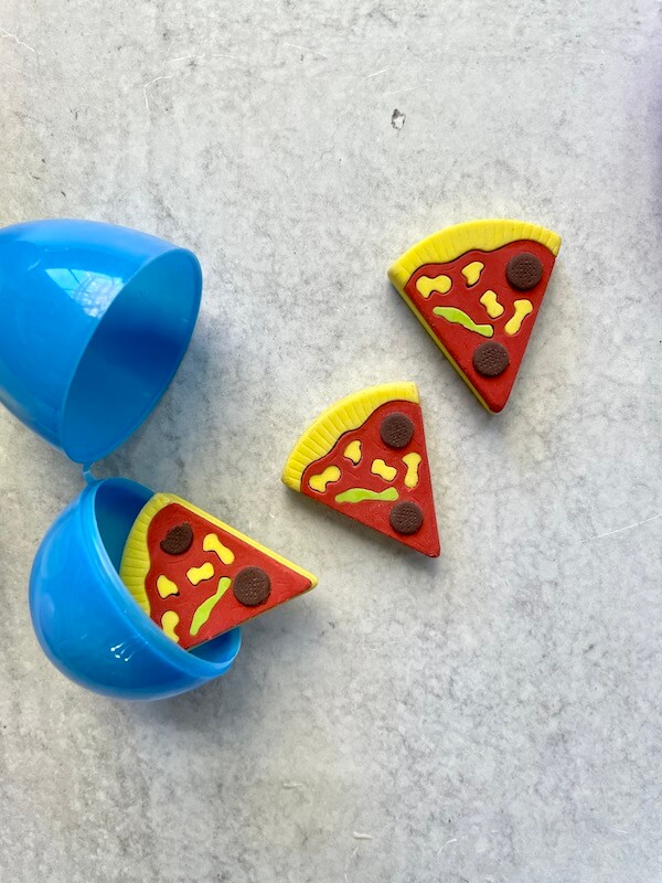 pizza shaped erasers in a plastic Easter egg