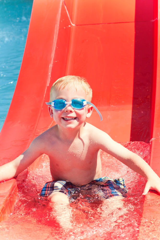 little boy on a water slide