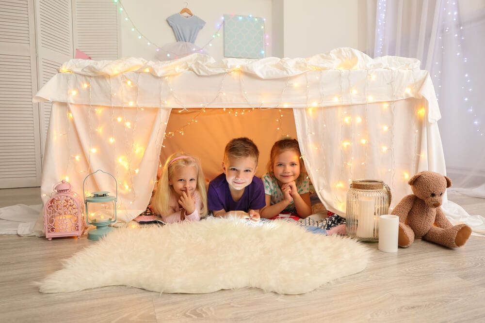 kids inside a blanket fort