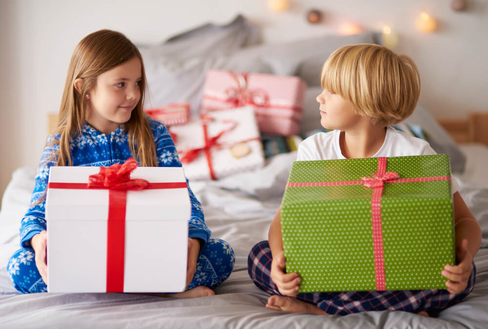 two kids holding gifts