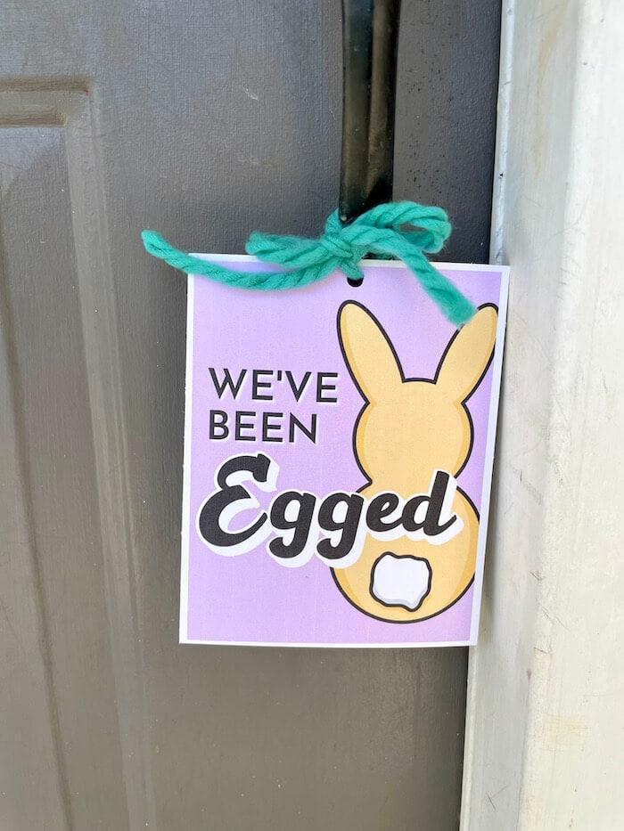 We've been egged sign hanging on a door knob