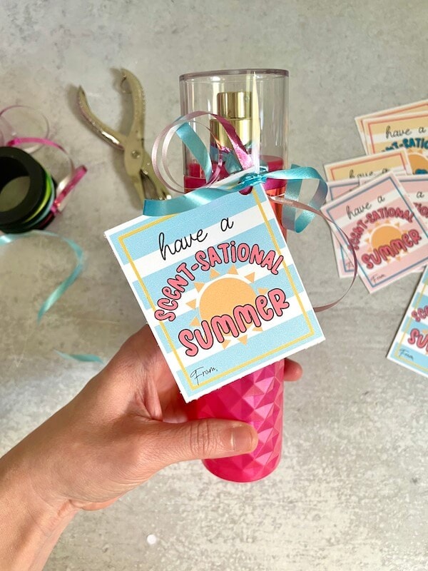 perfume with a gift tag that says have a scent-sational summer
