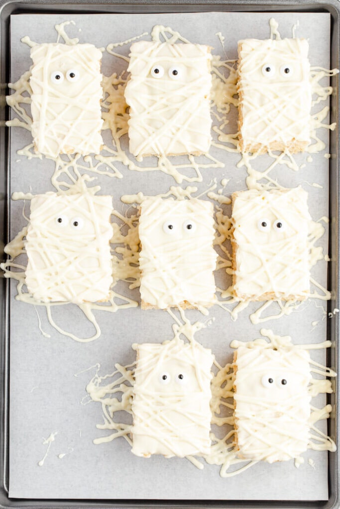 mummy rice krispie treats on a baking sheet